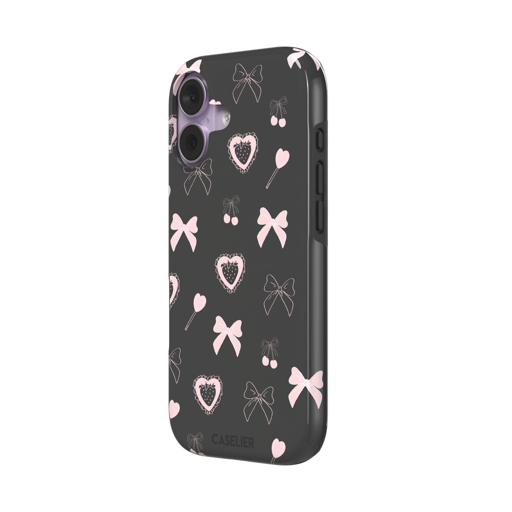 Sweetness Overload phone case in dark charcoal grey with pink bows, cherries, heart lollipops and frilled strawberry heart illustrations — tough case, right view