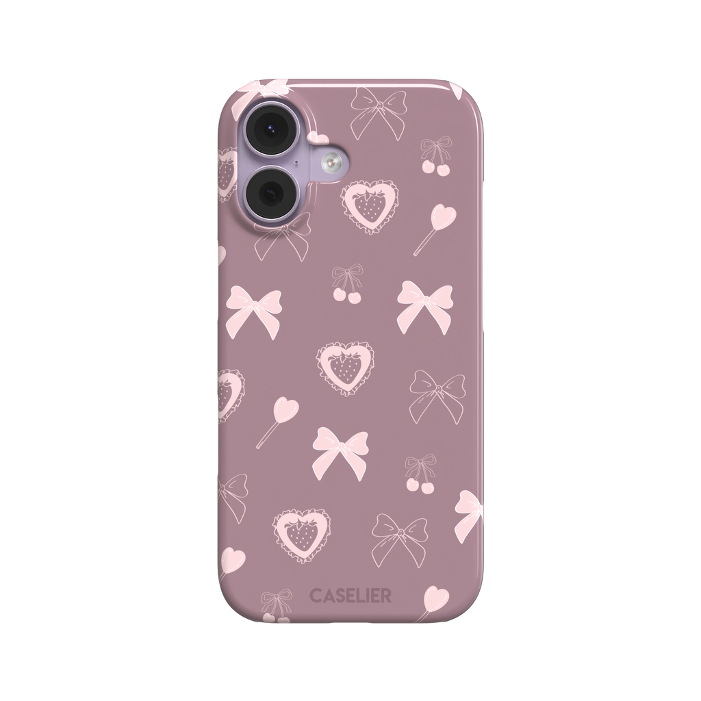 Sweetness Overload phone case in dusty pink with soft pink bows, cherries, heart lollipops and frilled strawberry heart illustrations — snap case, front view