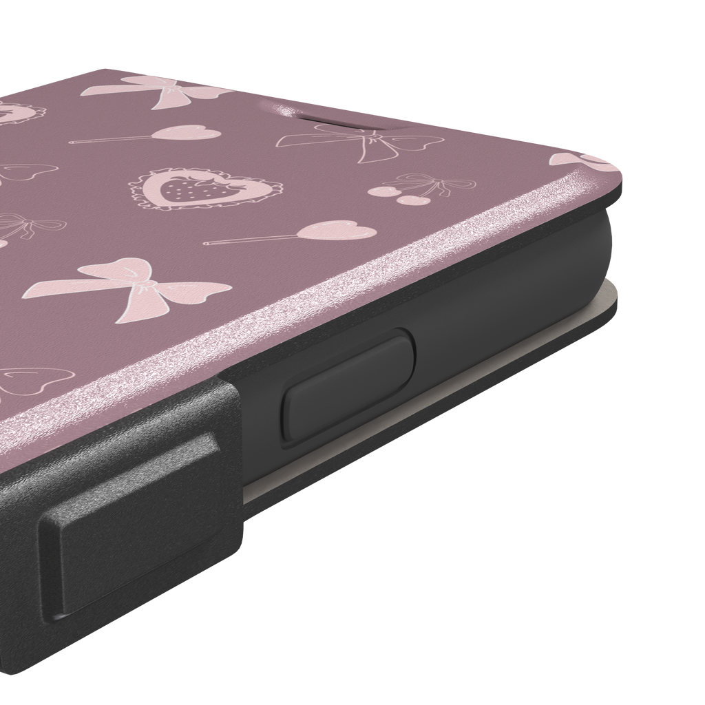 Sweetness Overload phone case in dusty pink with soft pink bows, cherries, heart lollipops and frilled strawberry heart illustrations — wallet case, volume buttons detail
