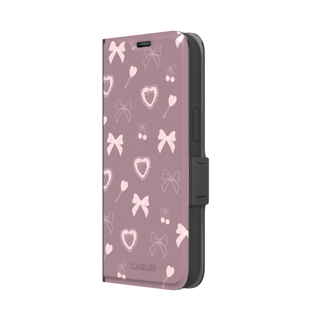 Sweetness Overload phone case in dusty pink with soft pink bows, cherries, heart lollipops and frilled strawberry heart illustrations — wallet case, right view