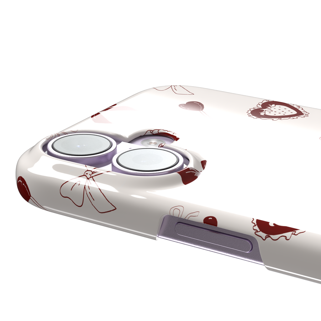 Sweetness Overload phone case in cream white with deep red bows, cherries, heart lollipops and frilled strawberry heart illustrations — snap case, volume buttons detail