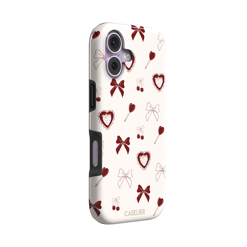 Sweetness Overload phone case in cream white with deep red bows, cherries, heart lollipops and frilled strawberry heart illustrations — tough case, left view