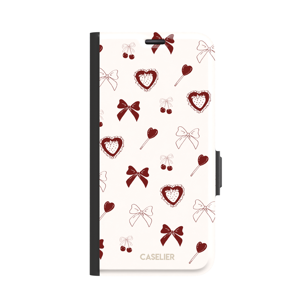 Sweetness Overload phone case in cream white with deep red bows, cherries, heart lollipops and frilled strawberry heart illustrations — wallet case, front view