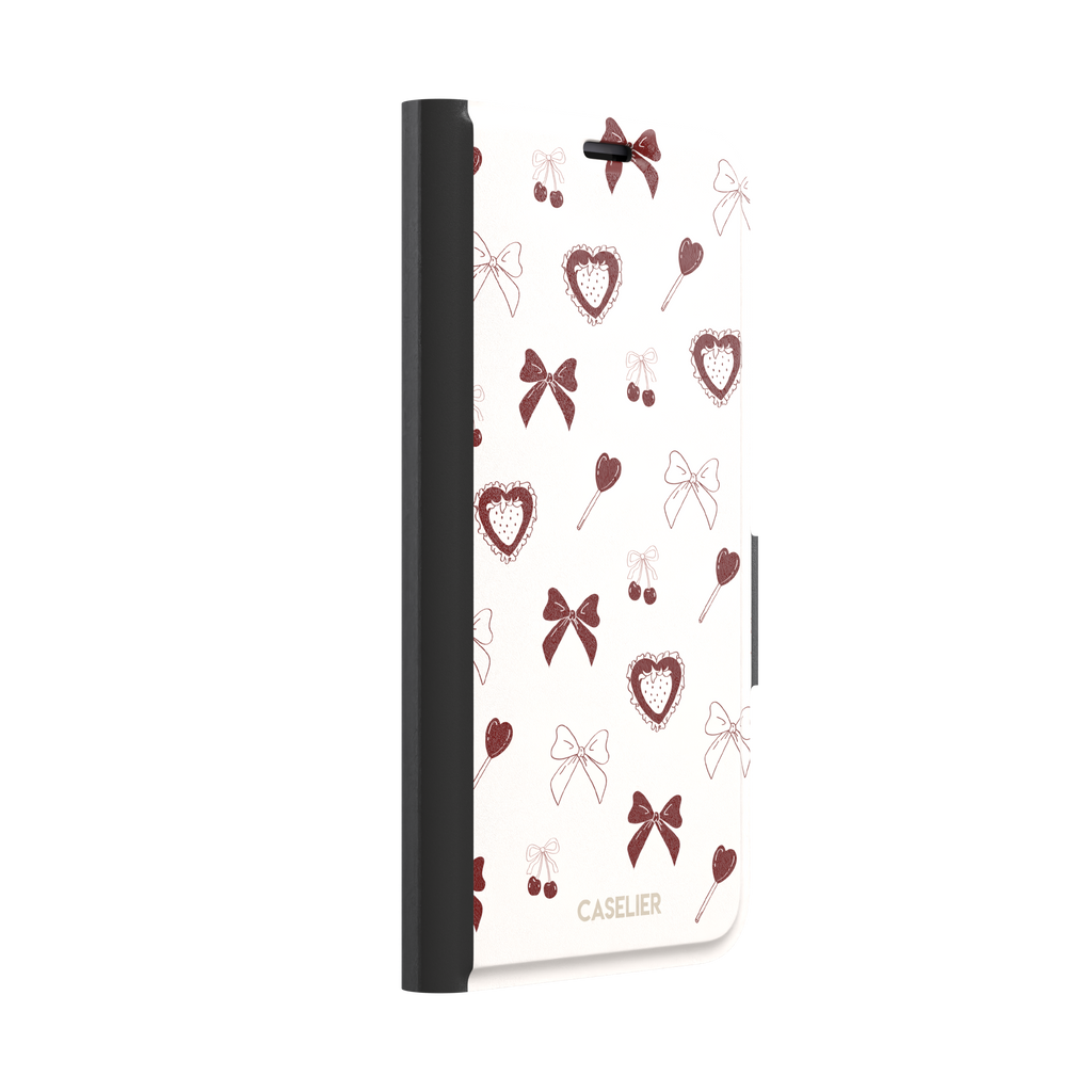 Sweetness Overload phone case in cream white with deep red bows, cherries, heart lollipops and frilled strawberry heart illustrations — wallet case, left view