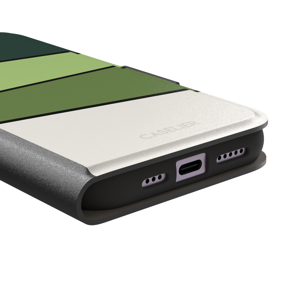 Tectonic Plates phone case variant in forest green, light green, olive and off-white diagonal color blocks with black dividing lines, phone case by Caselier — wallet case, charging port detail