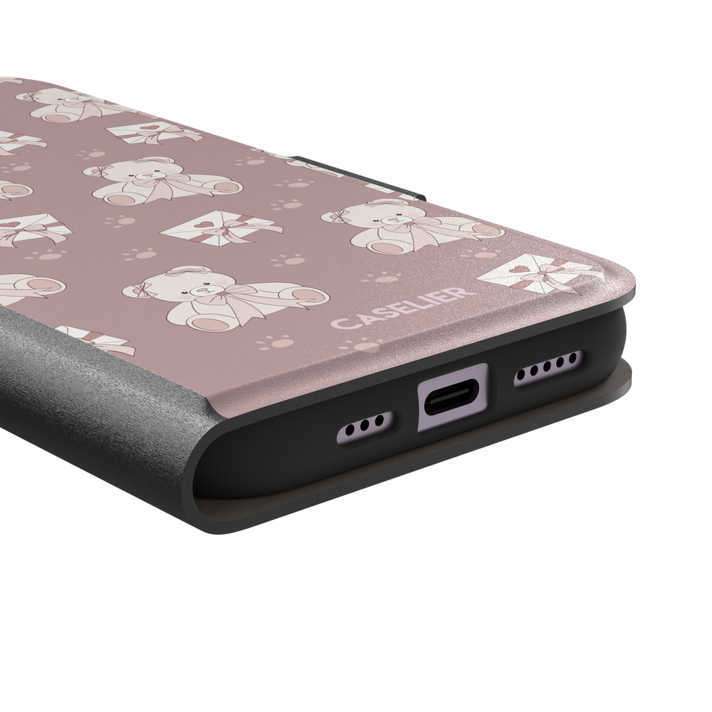 Ted the Teddy phone case in dusty mauve-pink colorway with cream teddy bears, ribbon bows and heart envelope motifs in a coquette repeat pattern, by Caselier — wallet case, charging port detail