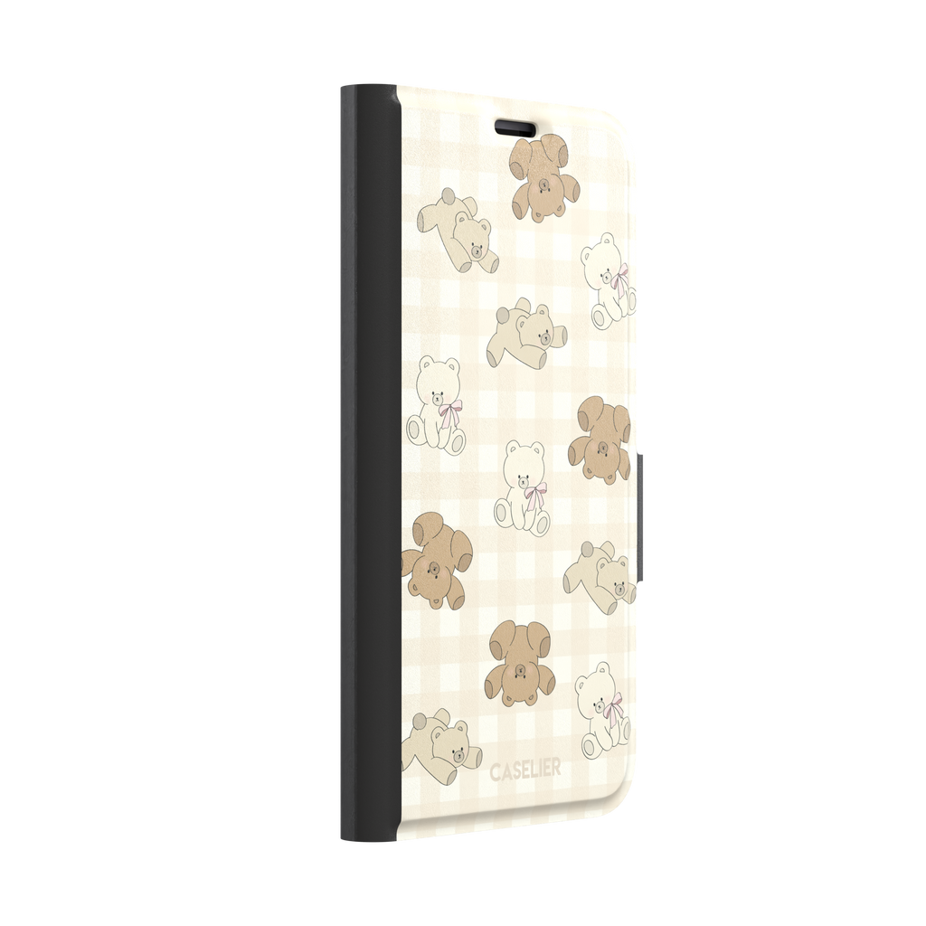 Teddybears phone case in warm cream with illustrated beige and ivory teddy bears scattered over a gingham grid pattern, some bears wearing soft pink bows — wallet case, left view