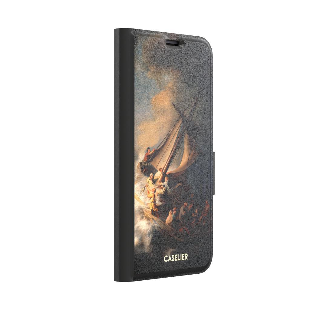 The Storm on the Sea of Galilee by Rembrandt, dark tempestuous ocean, golden-lit figures on a tilting sailboat with billowing sails and dramatic chiaroscuro — wallet case, left view