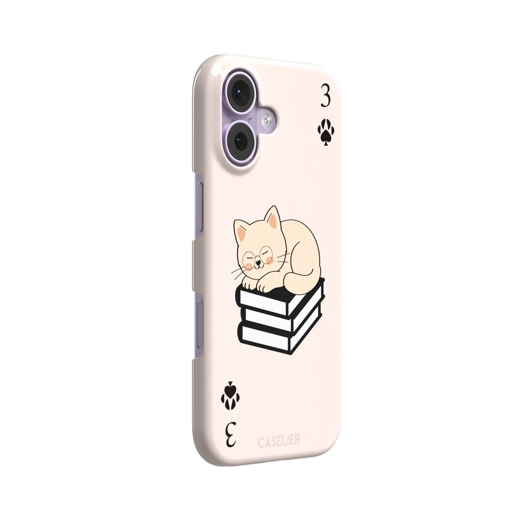 Three of Spades phone case in blush pink with a sleepy illustrated cat resting on stacked books and paw print spade symbols at each corner, by Caselier — snap case, left view