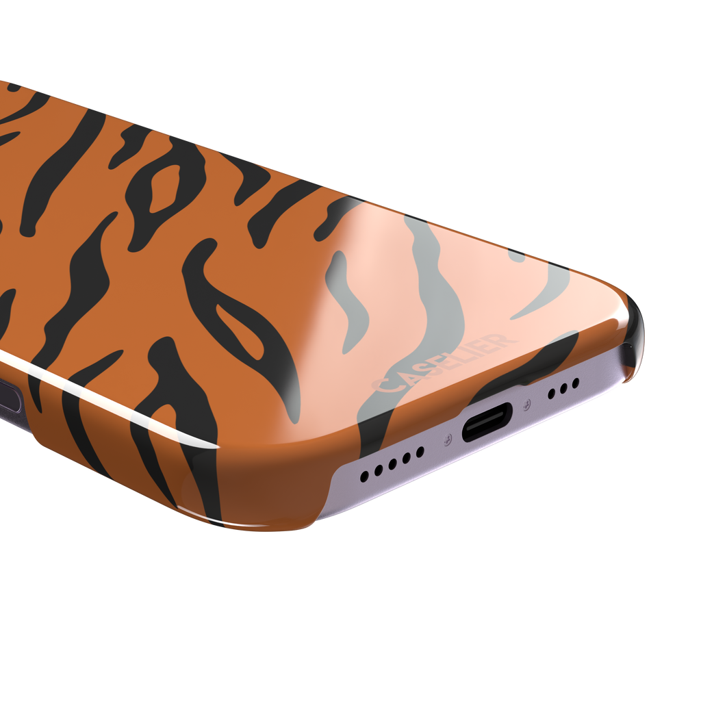 Tiger print phone case in orange with bold black stripes, full-bleed animal print design, phone case by Caselier — snap case, charging port detail