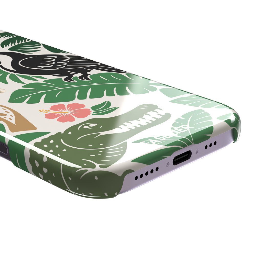 Tropical phone case in cream with bold flat-art illustration of a leopard, toucan, crocodile, hibiscus flower, and green palm and monstera leaves with golden banana accents — snap case, charging port detail