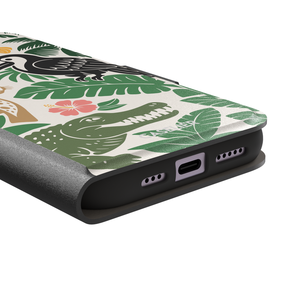 Tropical phone case in cream with bold flat-art illustration of a leopard, toucan, crocodile, hibiscus flower, and green palm and monstera leaves with golden banana accents — wallet case, charging port detail