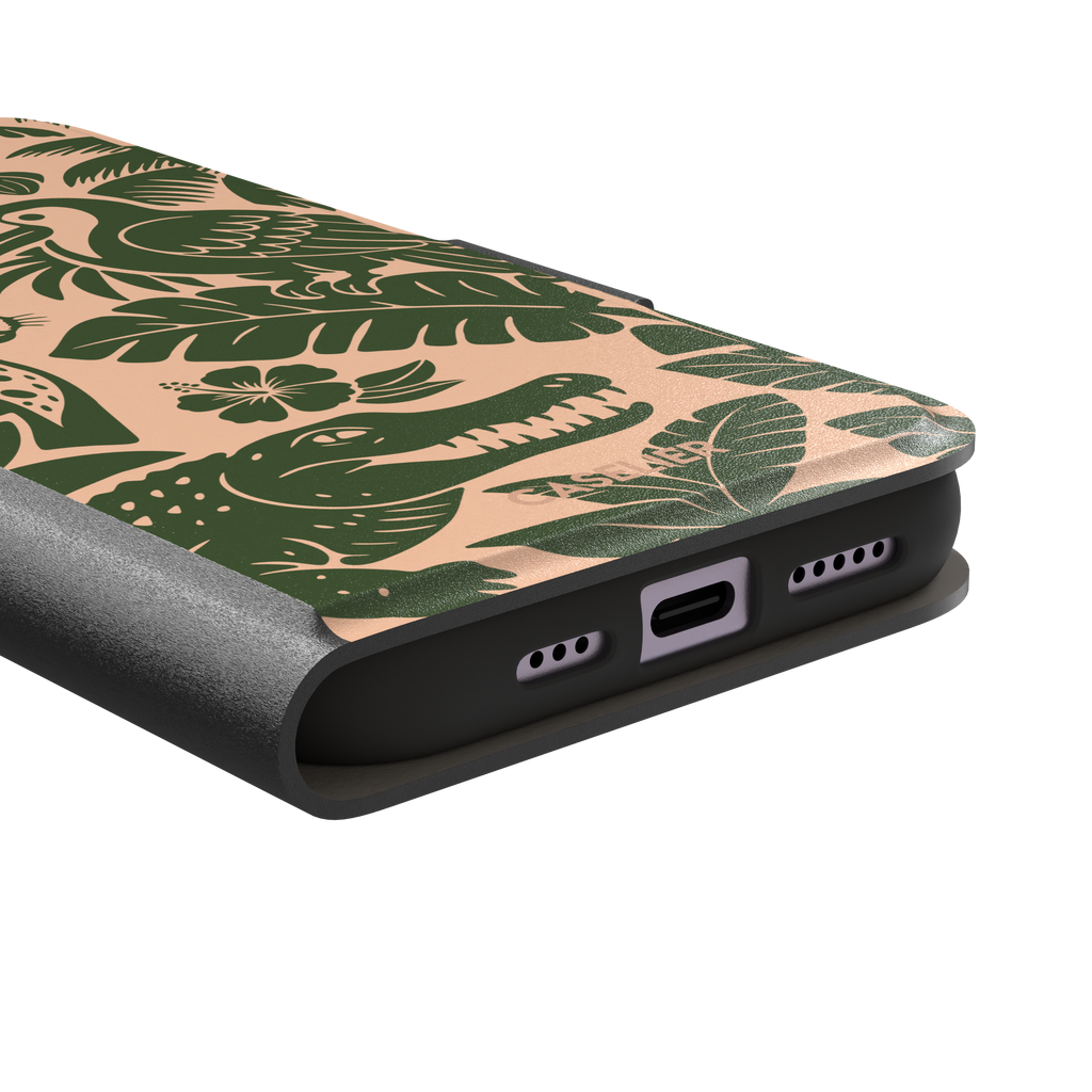 Tropical phone case in peach and dark green two-tone colorway featuring the jungle illustration with leopard, toucan, crocodile, monstera leaves, and hibiscus — wallet case, charging port detail