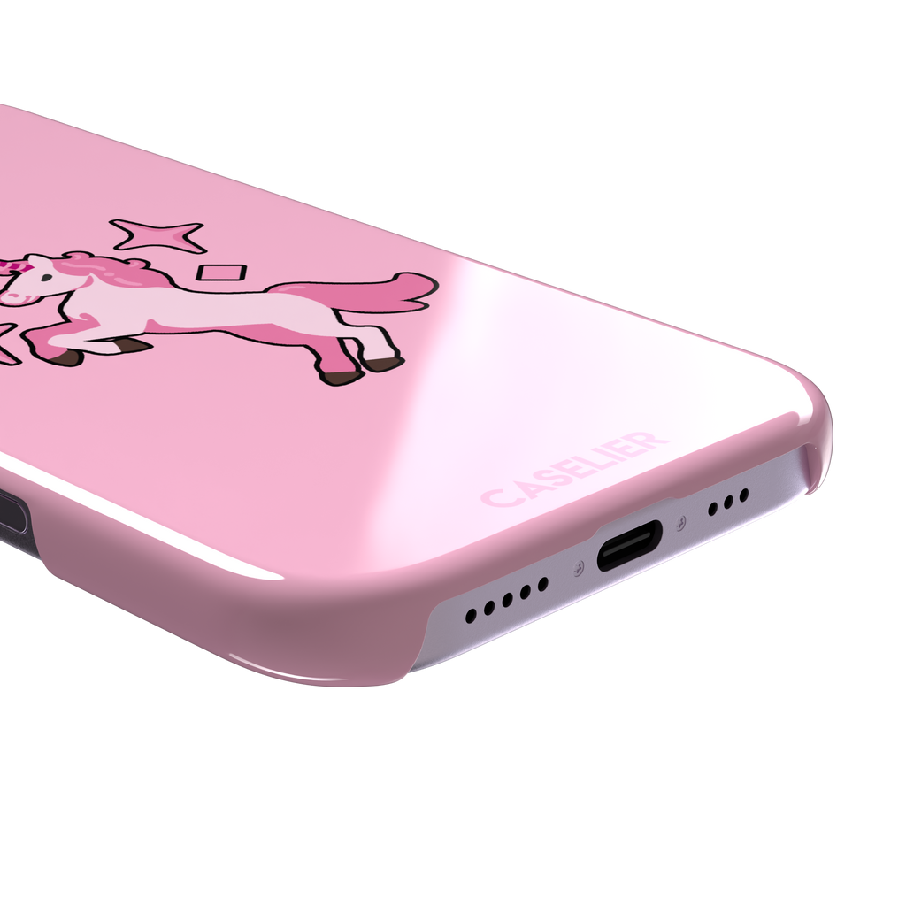 Pink kawaii unicorn rearing up with sparkle stars on a bubblegum-pink phone case by Caselier — snap case, charging port detail