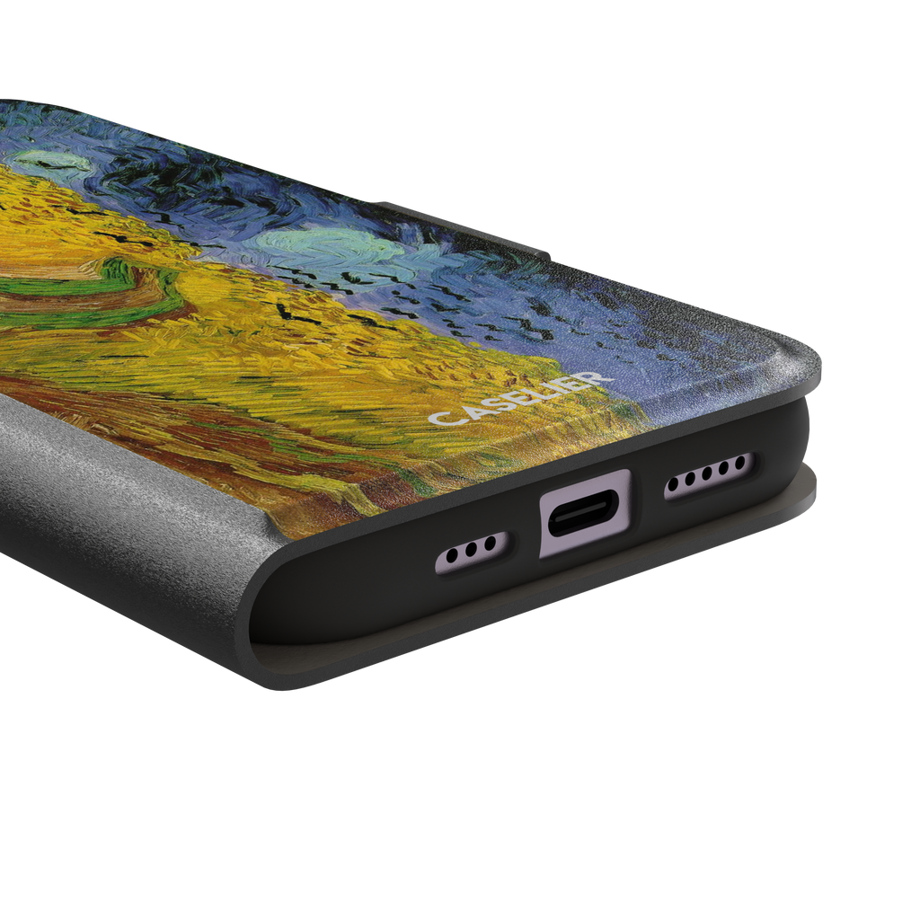 Wheatfields with Crows by Vincent van Gogh phone case showing golden wheat fields, swirling indigo sky and scattered crows in thick impasto brushwork, phone case by Caselier — wallet case, charging port detail